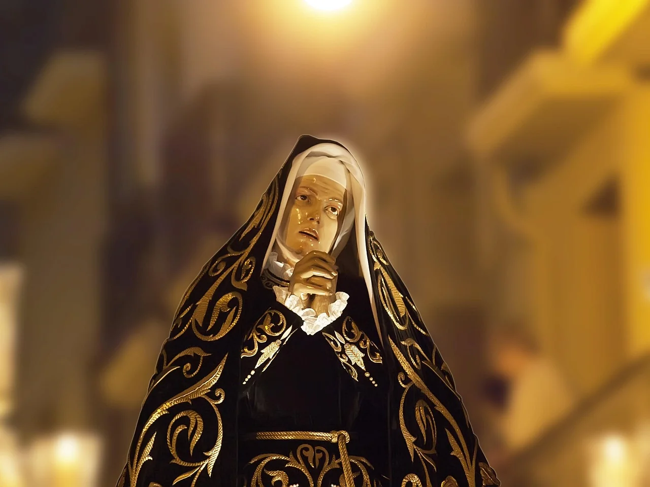 A church candle lit in devotion, symbol of prayer and the Marian feast observed on August 15