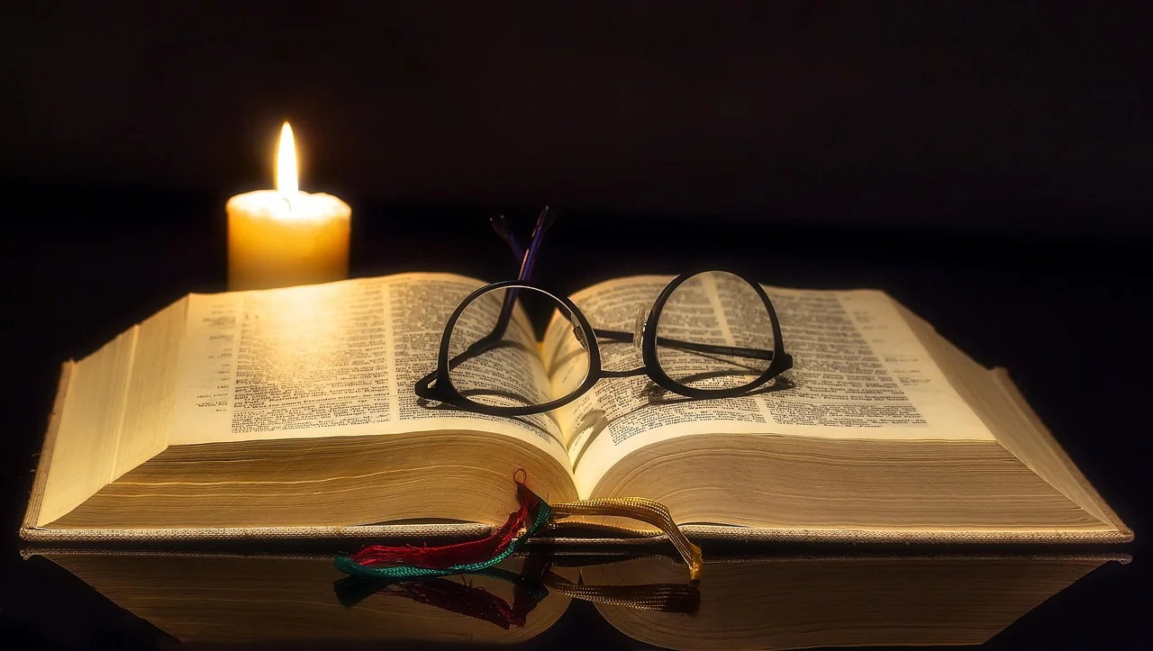 Person reading an open Bible with morning light, representing the personal encounter with Scripture