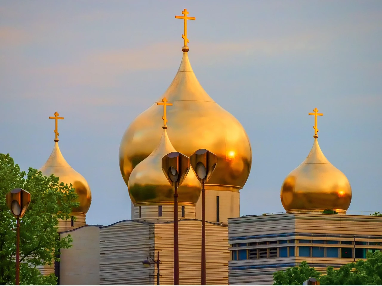 Candle flame glowing before a golden Orthodox icon, symbolizing contemplative prayer