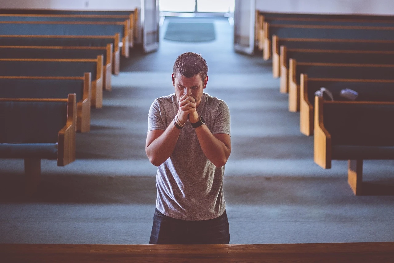 Family praying together around a table, representing communal Christian prayer